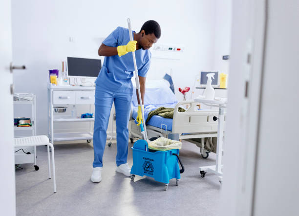 Male worker mopping the floor at the medical clinic